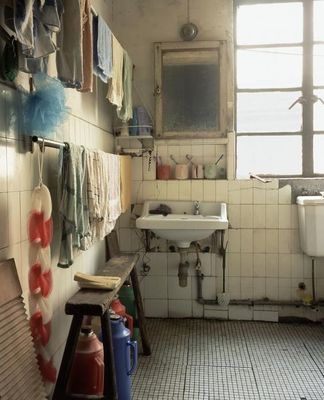 a bathroom with a sink, mirror, and tiled floor