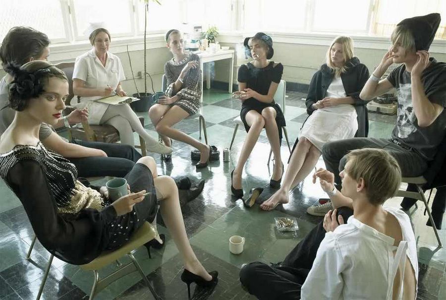 a group of women sitting around each other