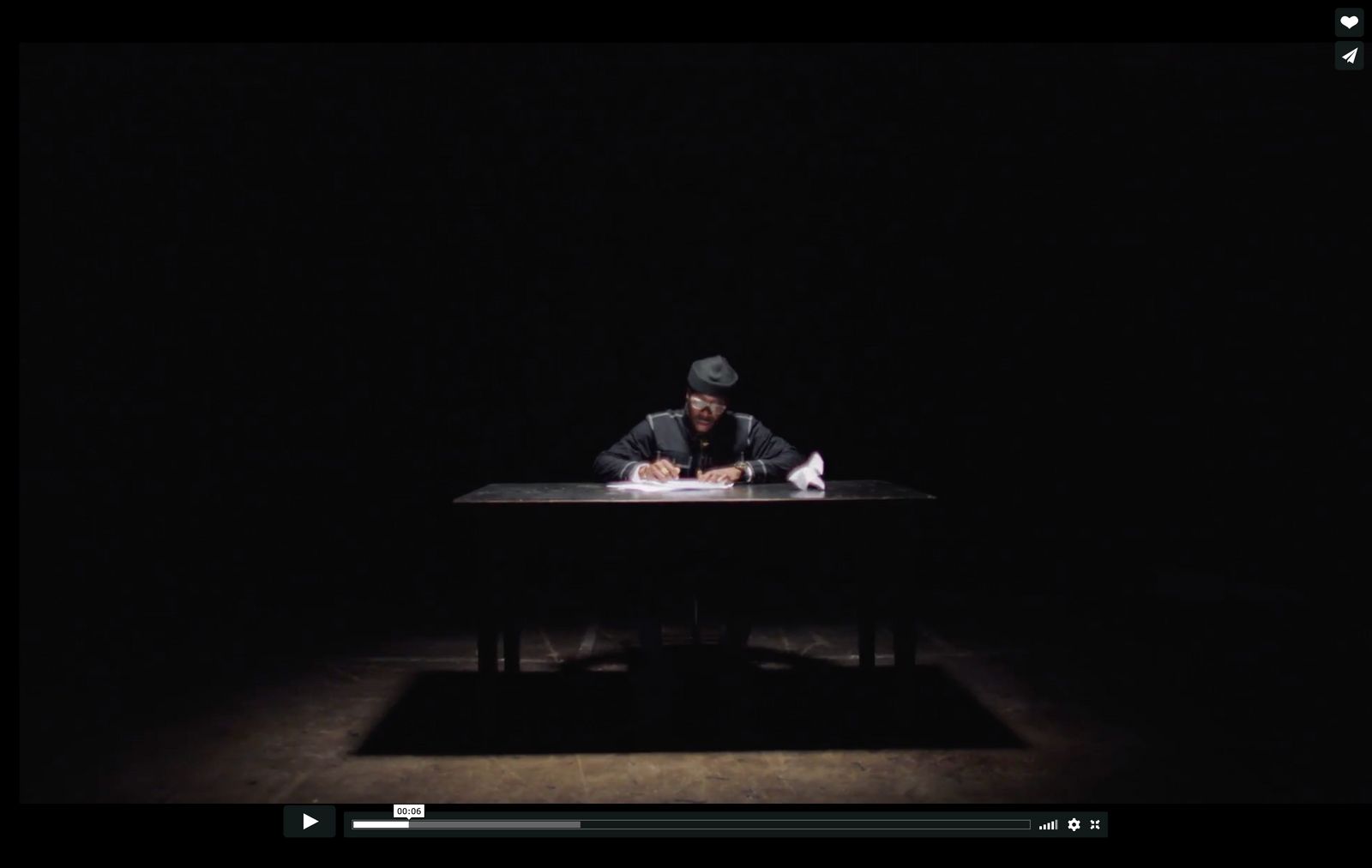 a man sitting at a table in the dark