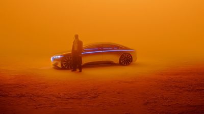 a man standing in front of a futuristic car