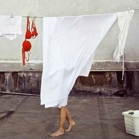 a woman is hanging out on a clothes line