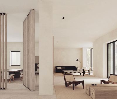 a living room filled with furniture next to tall windows