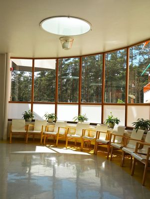 a room with a lot of windows and chairs