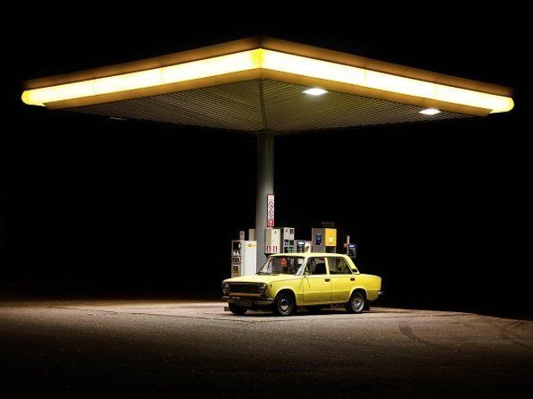 a yellow truck parked in front of a gas station