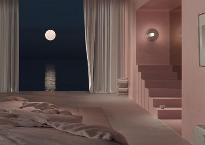 a bedroom with a view of the ocean at night