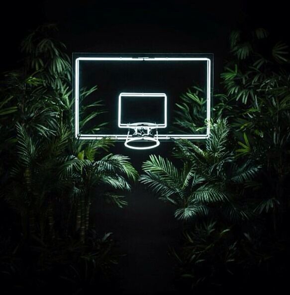 a basketball hoop lit up in the dark