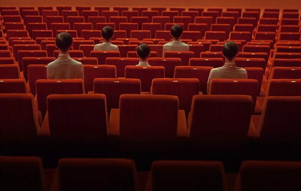 a group of people sitting in a movie theater