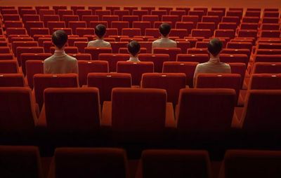 a group of people sitting in a movie theater