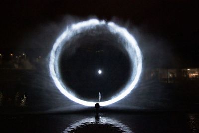 a person standing in front of a circular object