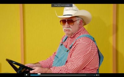 a man wearing a cowboy hat and sunglasses