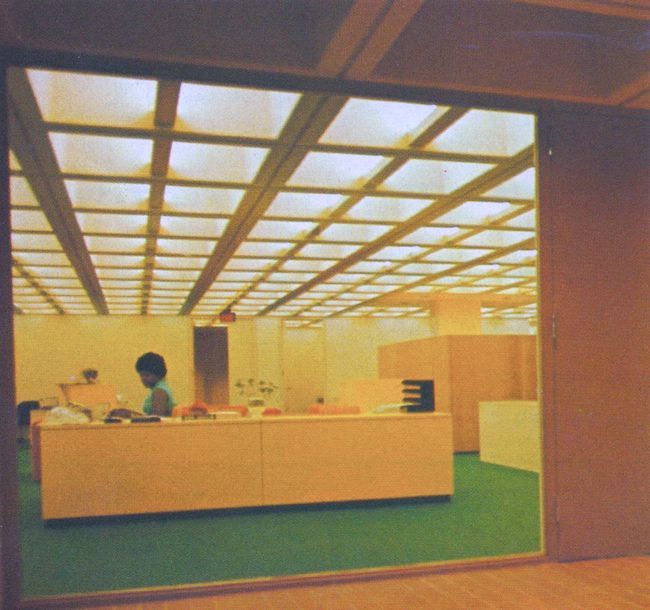 a person sitting at a desk in an office