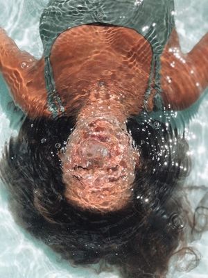 a person floating in a pool of water