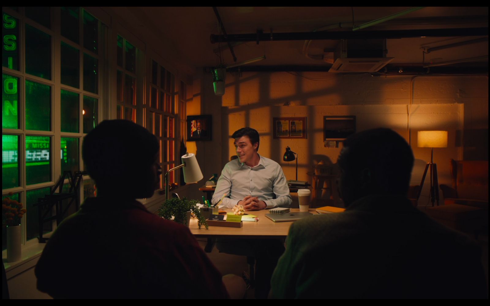 a man sitting at a table in a dimly lit room