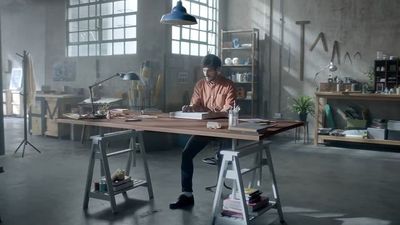 a man sitting at a desk in a room