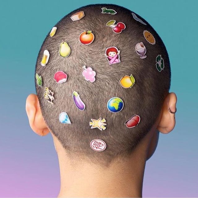 a man's head with a bunch of stickers on it