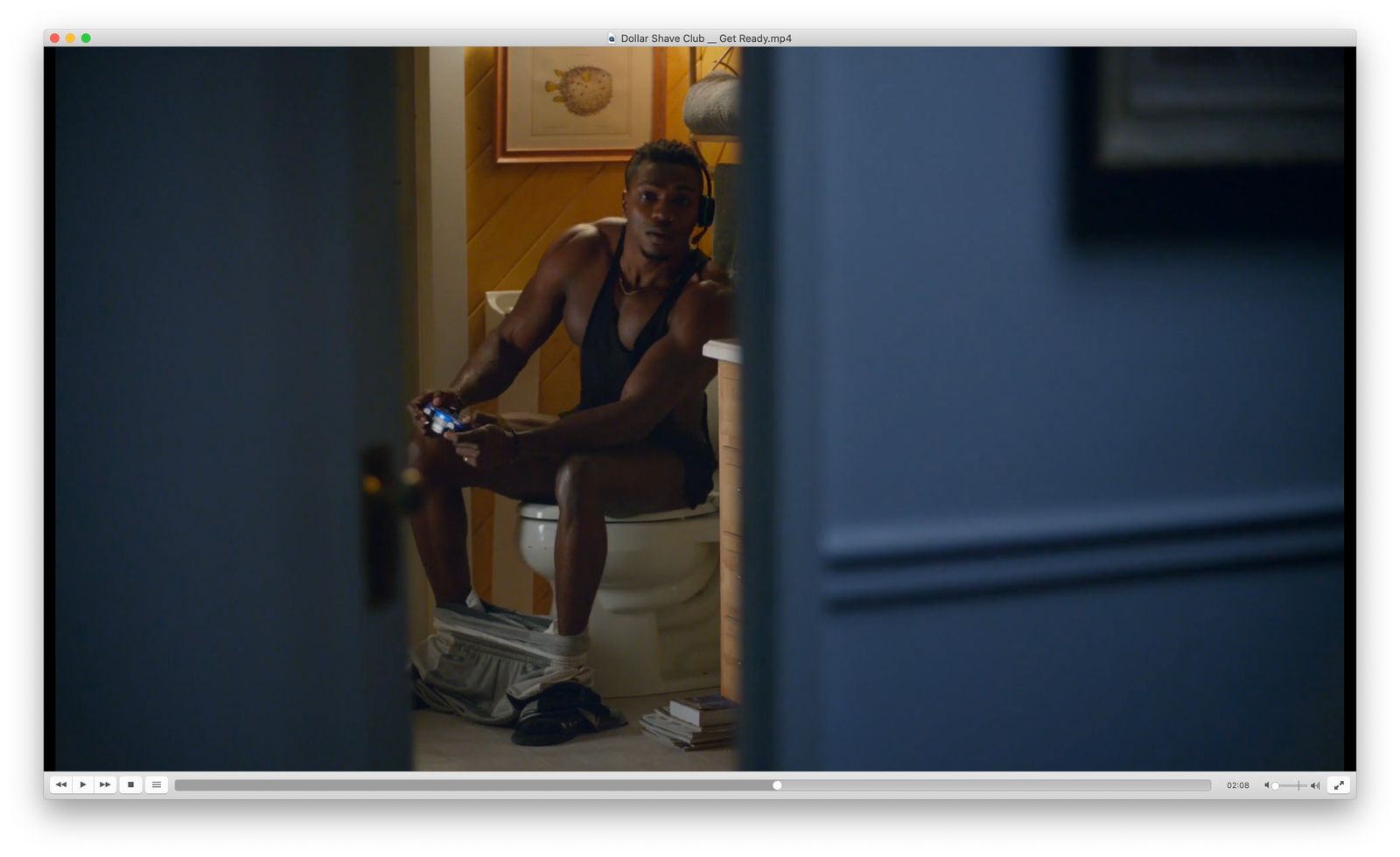 a man sitting on a toilet talking on a cell phone