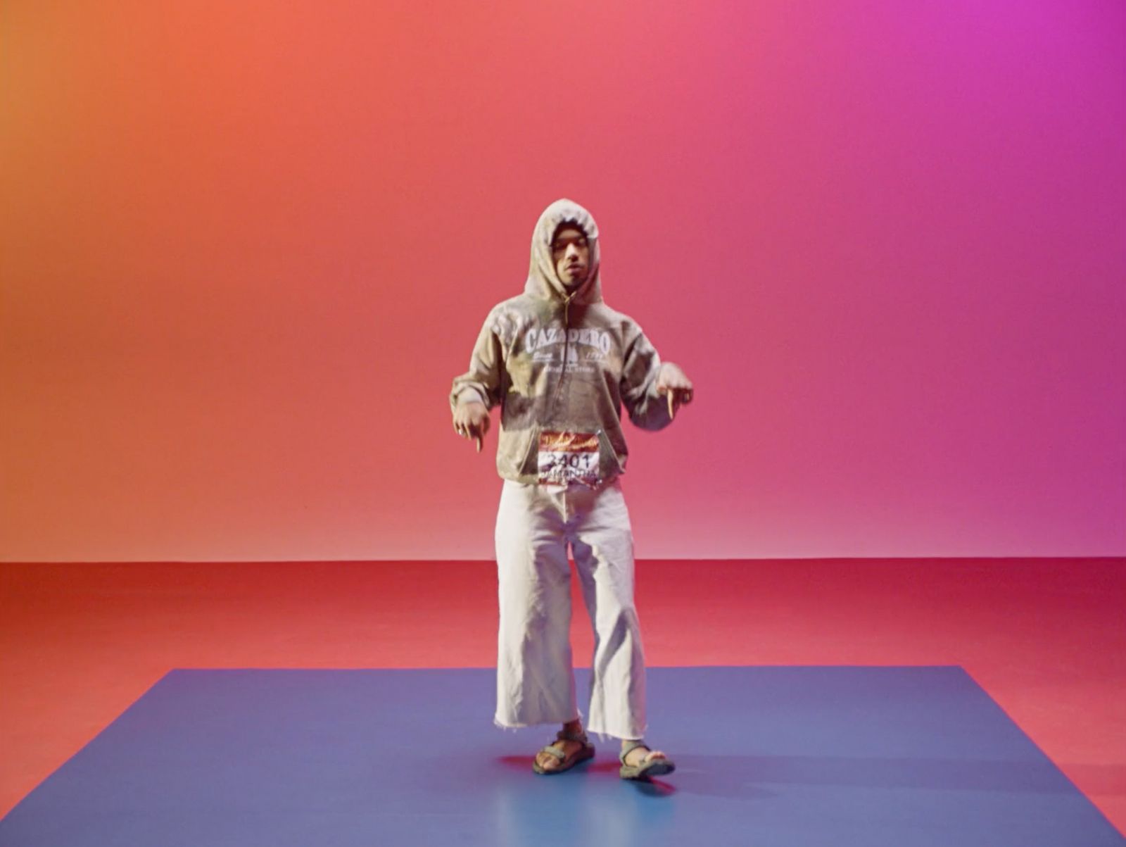 a man standing on a blue and purple surface