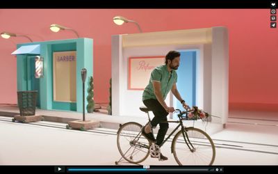 a man riding a bike in front of a store