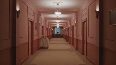 a long hallway with a table and chairs