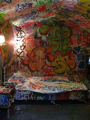 a bedroom with graffiti all over the walls