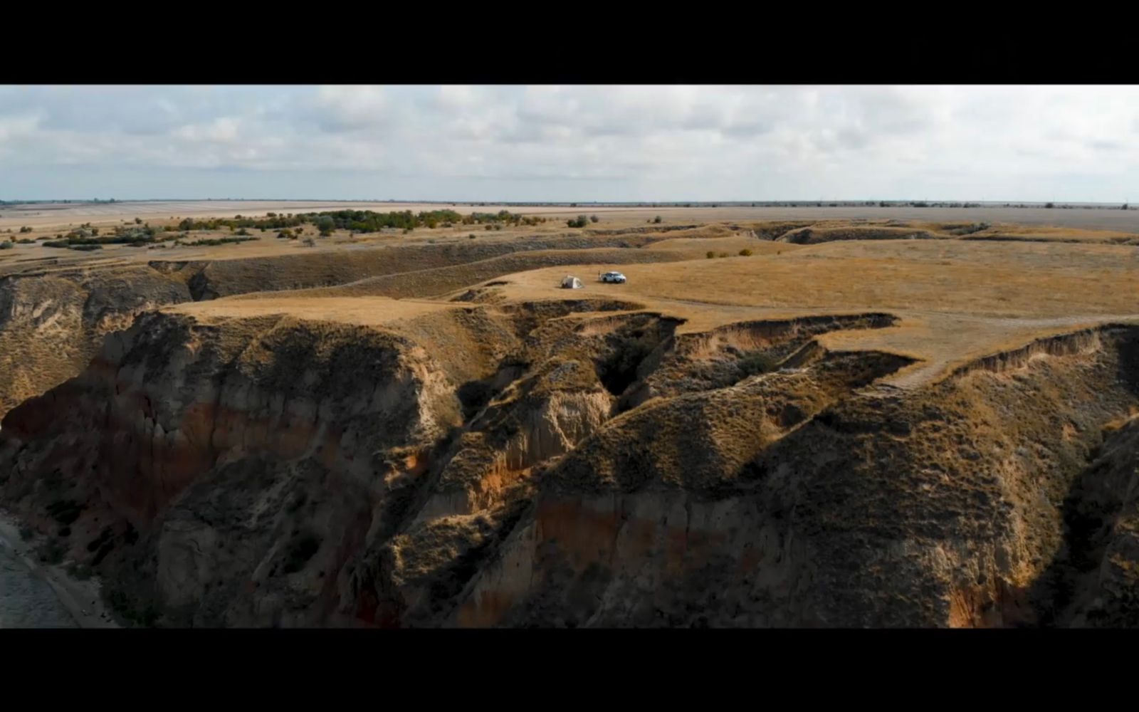 an aerial view of a desert with a river running through it