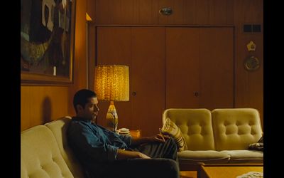 a man sitting on a couch in a living room