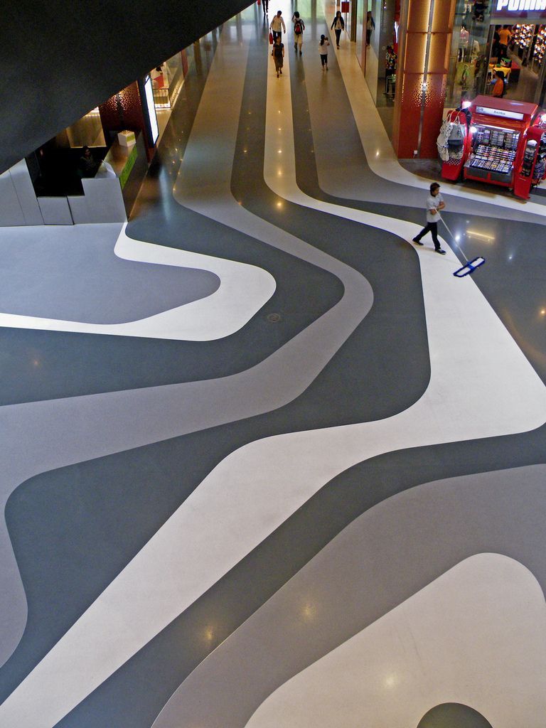 a person walking through a building with a skateboard