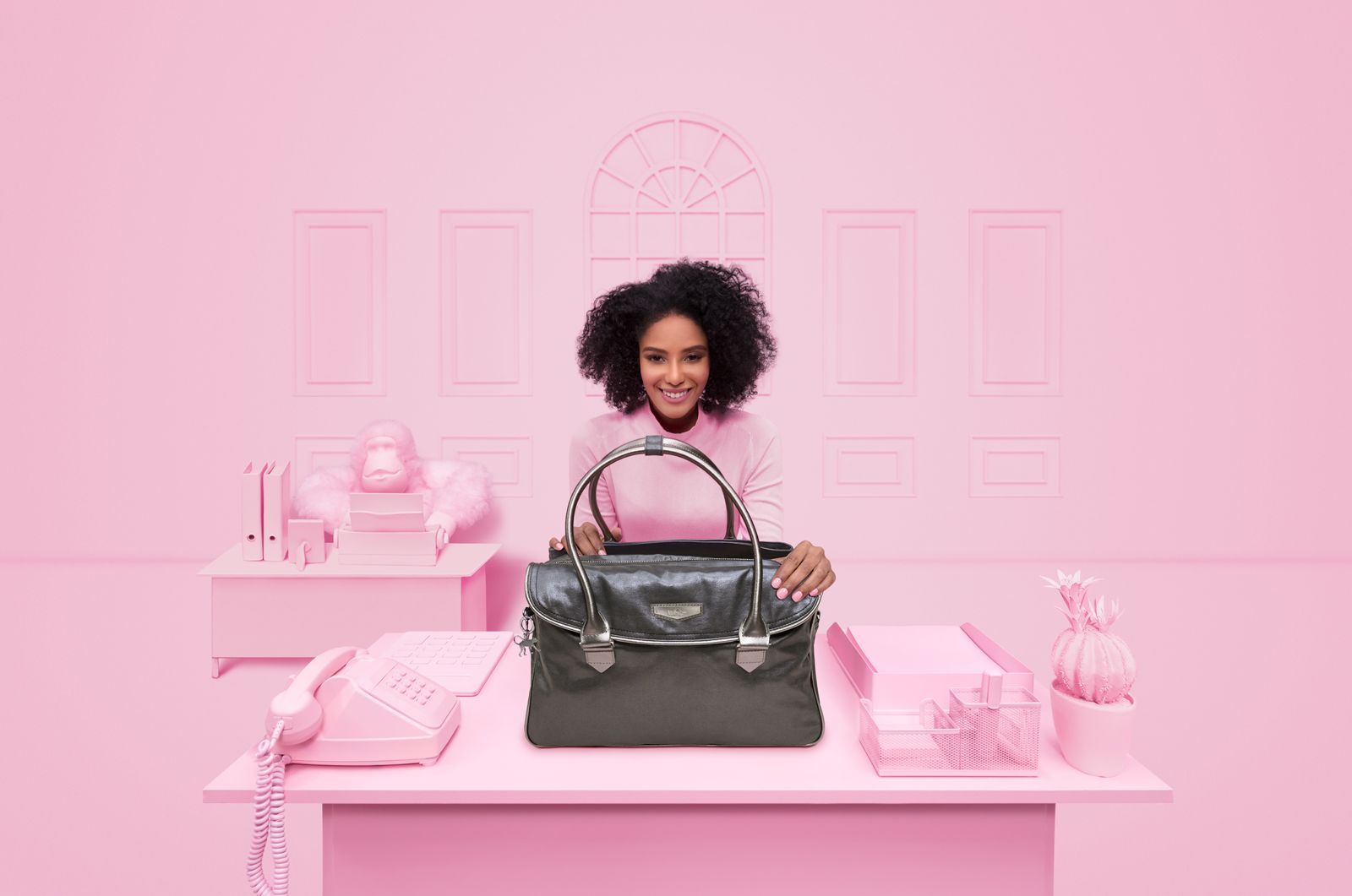 a woman sitting at a desk with a purse