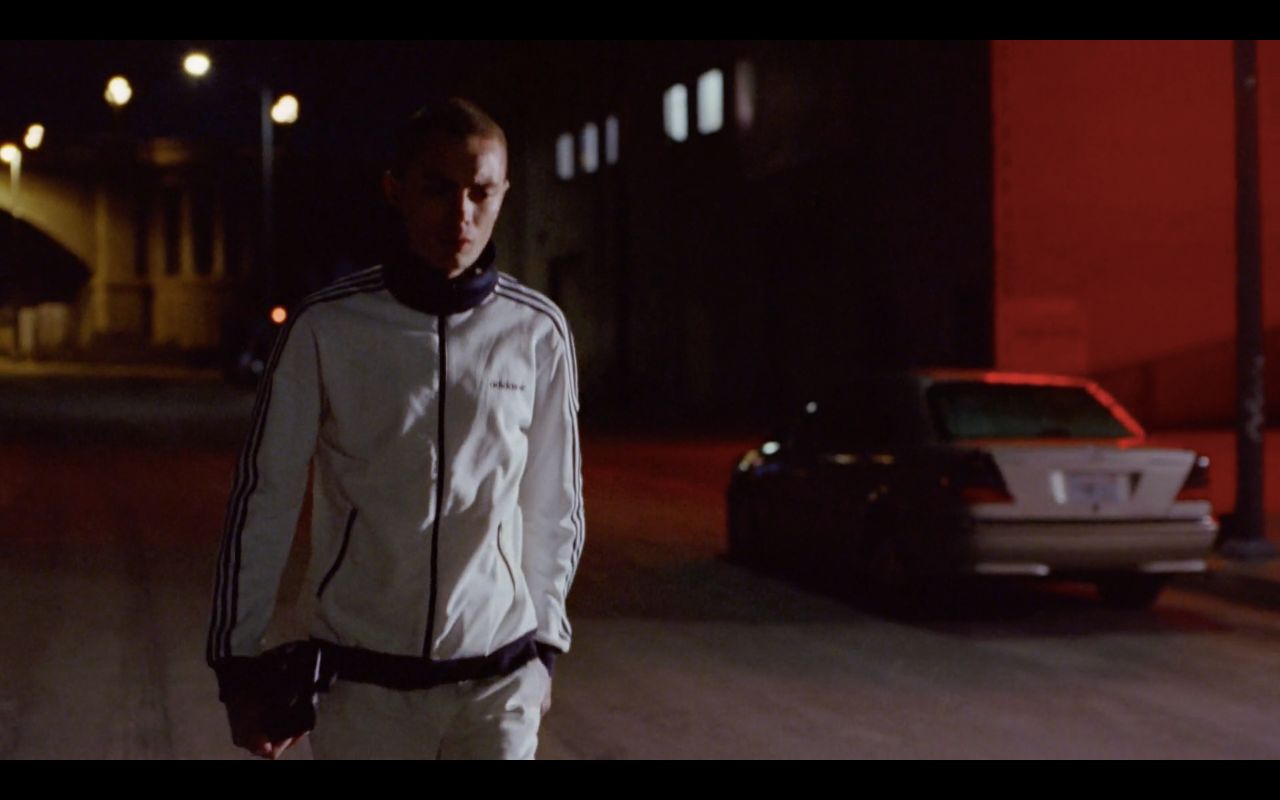 a man walking down a street at night