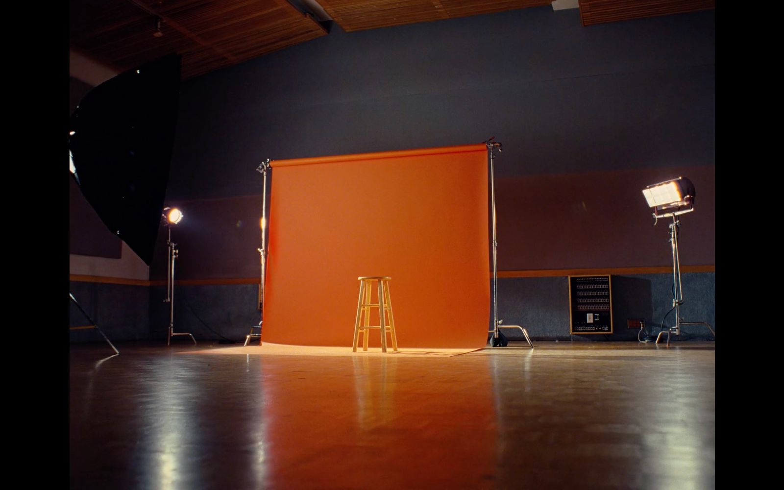 a photo studio with a large orange screen