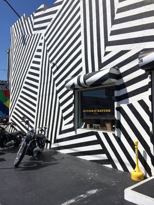 a black and white building with a bike parked in front of it