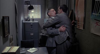 a couple of men hugging each other in a room