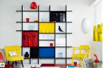 a living room filled with furniture and a book shelf