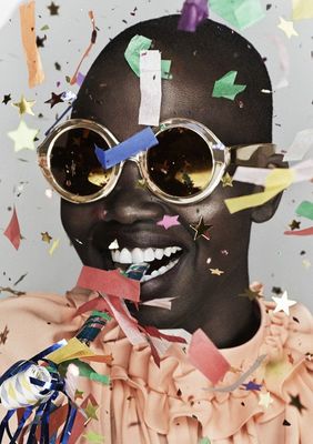 a woman with sunglasses and confetti on her face