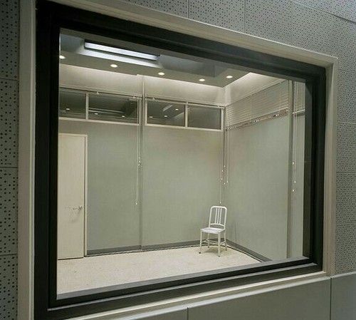 a white chair sitting in front of a mirror