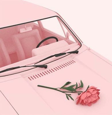 a pink car with a flower on the hood