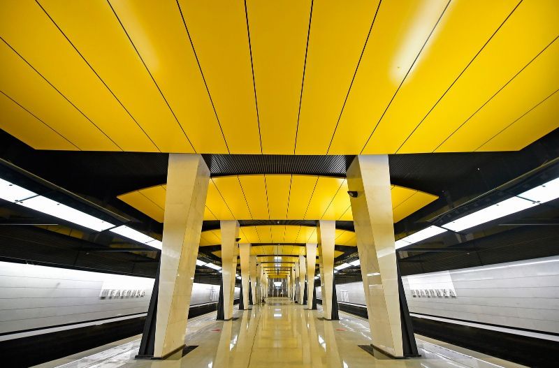 a long hallway with yellow and black ceilinging