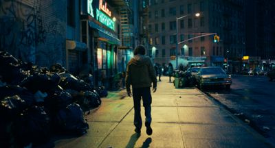 a man walking down a street at night