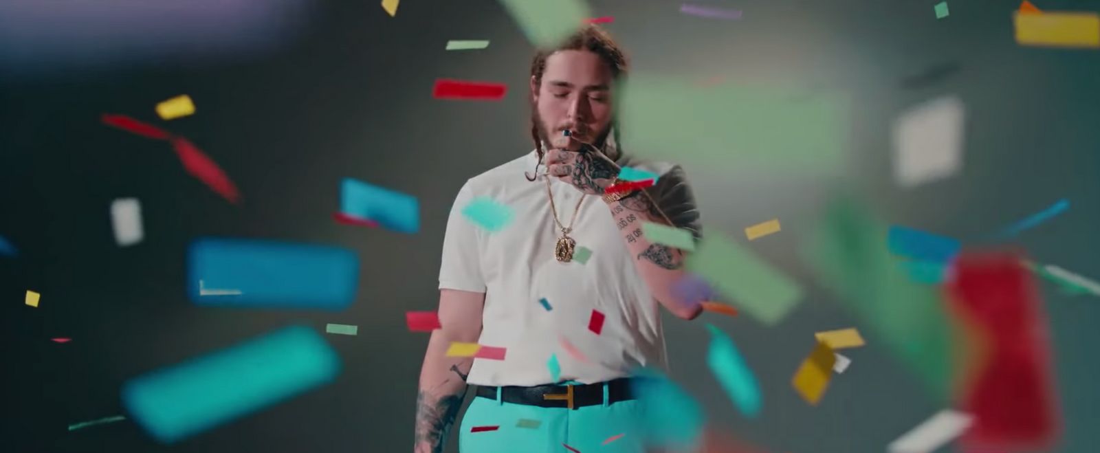 a man standing in front of confetti and confetti