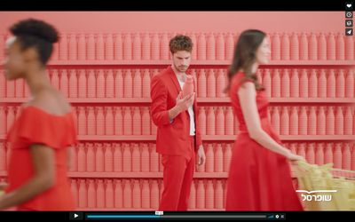 a man in a red suit standing next to a woman in a red dress