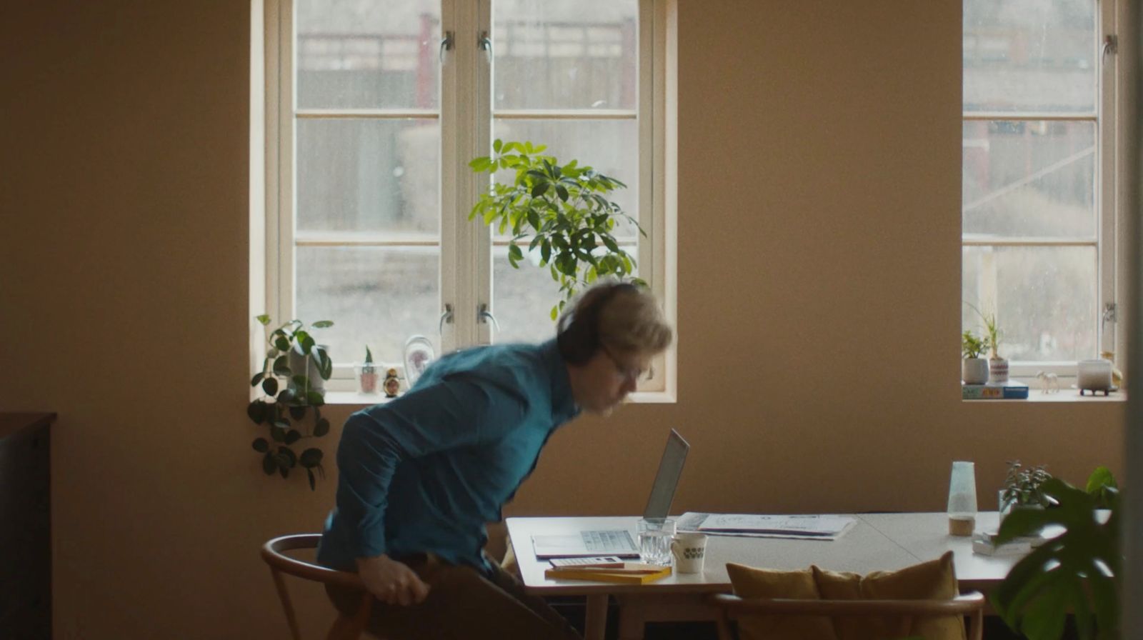 a person sitting at a table with a laptop