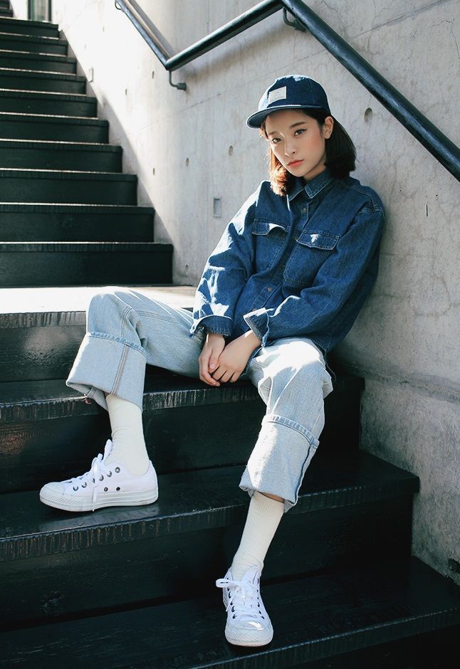 a young woman sitting on a set of stairs