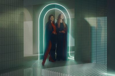 a couple of women standing next to each other in a bathroom