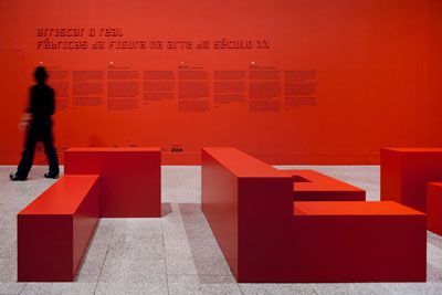 a person standing in front of a red wall