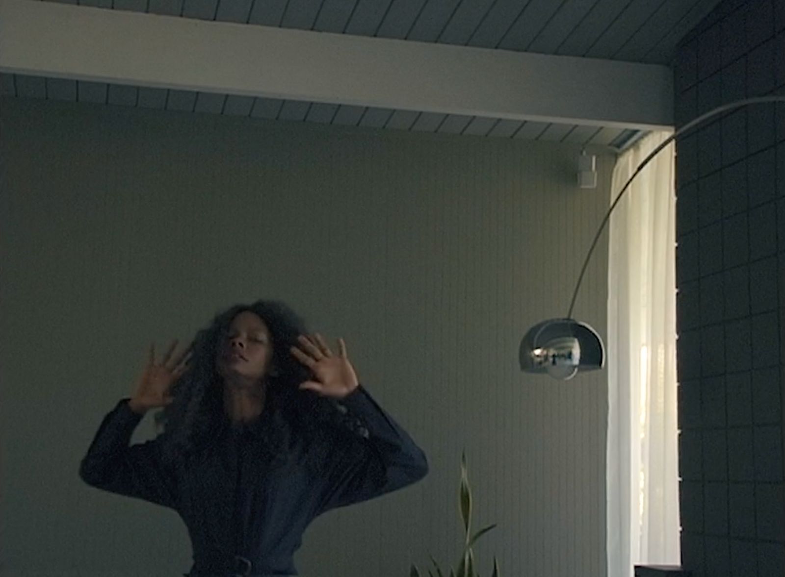 a woman standing in front of a mirror in a bathroom