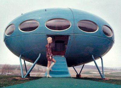 a woman standing in the doorway of a blue airplane