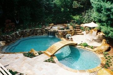 a backyard with a pool and a waterfall