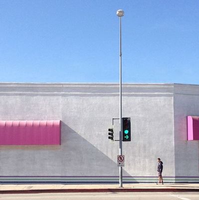 a person standing next to a traffic light