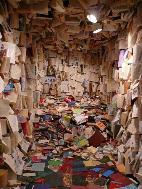 a room filled with lots of books and papers