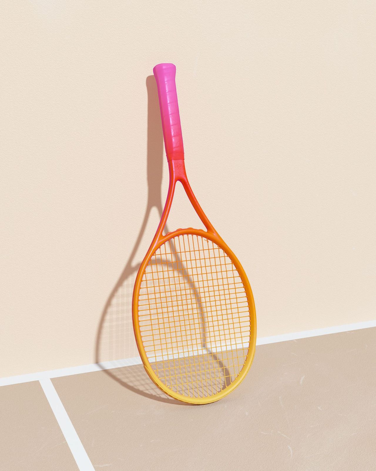 a yellow and pink tennis racket hanging on a wall